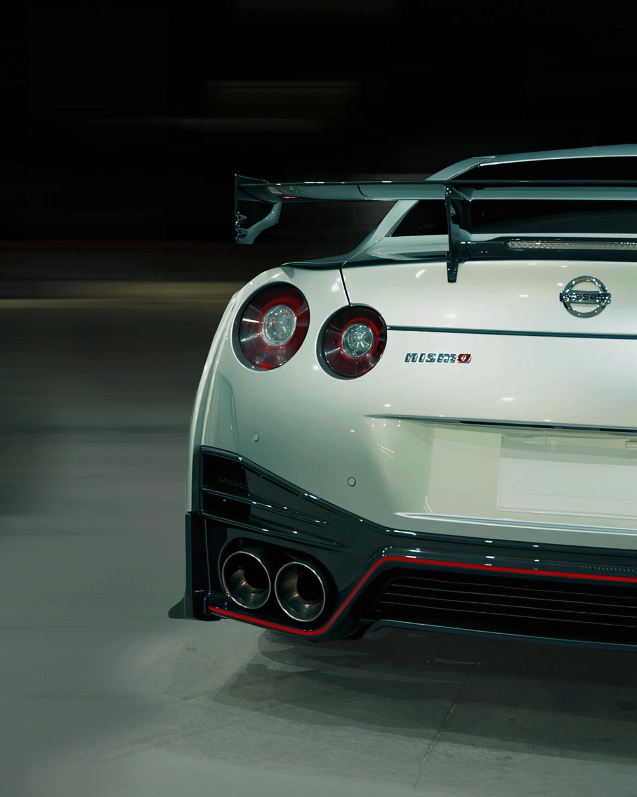 White Nissan GT-R rear three-quarter at night