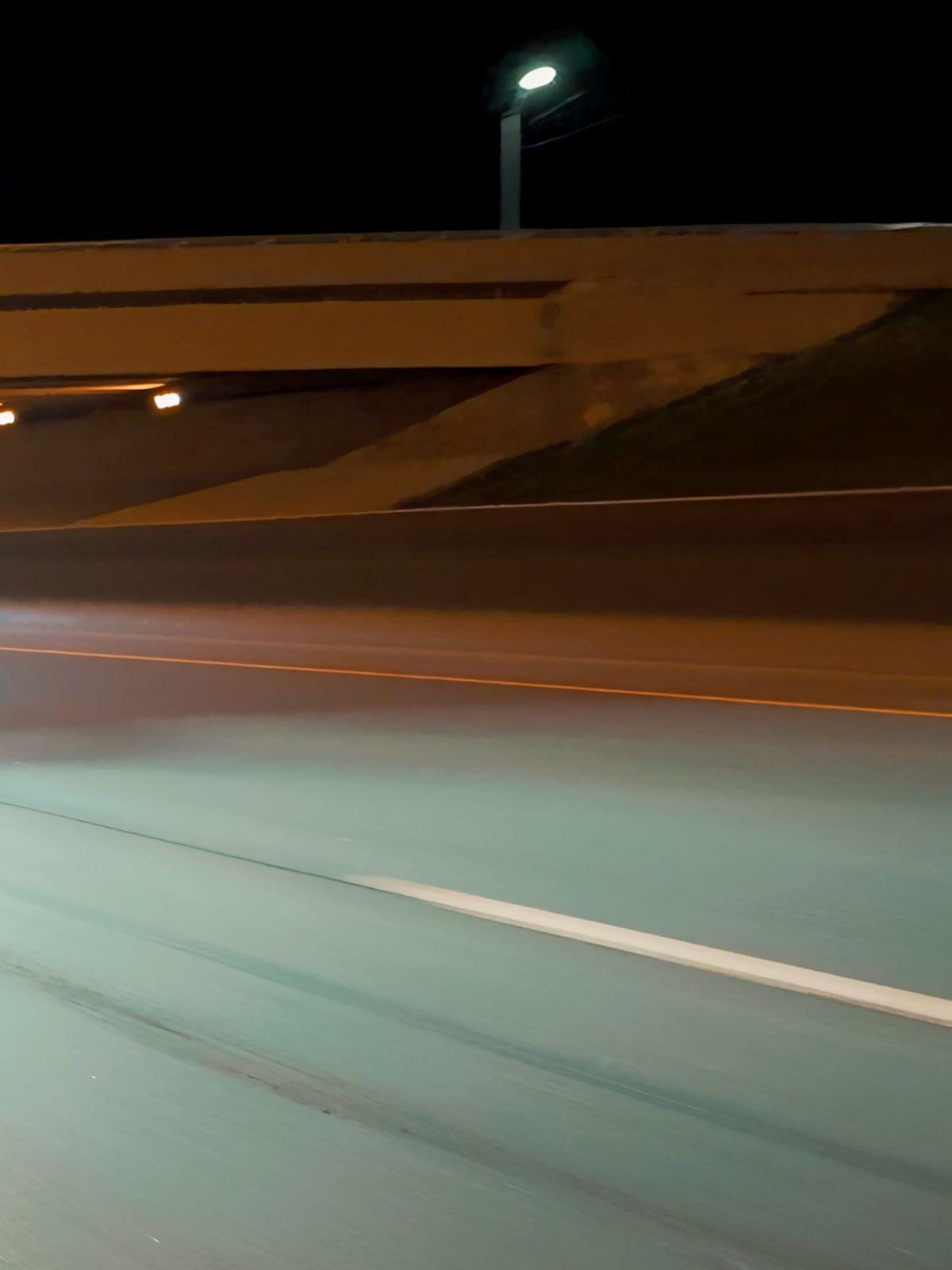 Light trails on a highway under an overpass at night