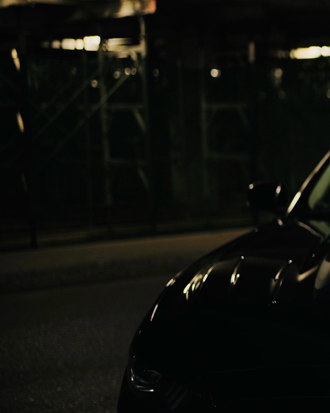 Dark car in a parking garage at night